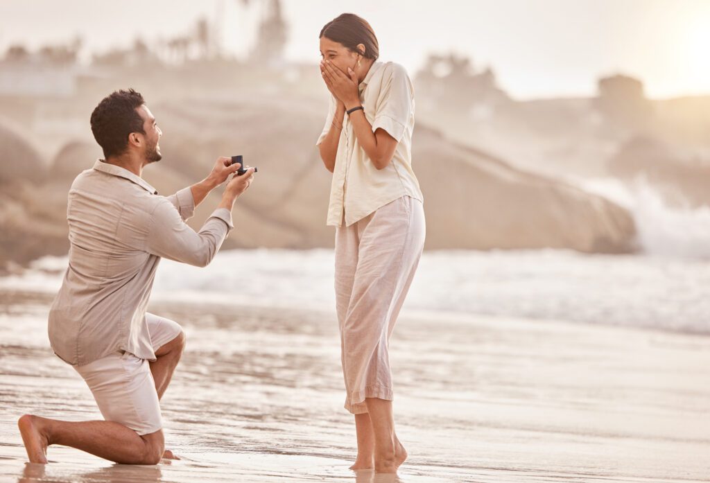couple getting engard. Man proposing to woman at the beach. charleston, sc. Now they must ask questions before the wedding